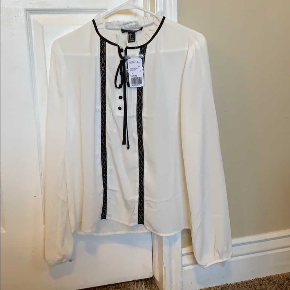 White blouse with tie neck.